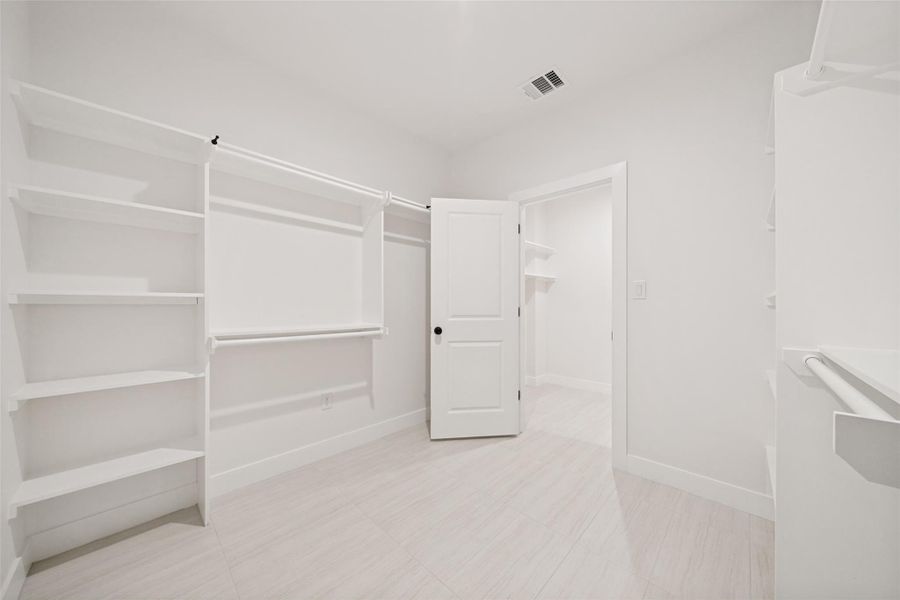 Ample shelving and hanging space defines this generously sized walk-in closet. Ample shelving and hanging space defines this generously sized walk-in closet.