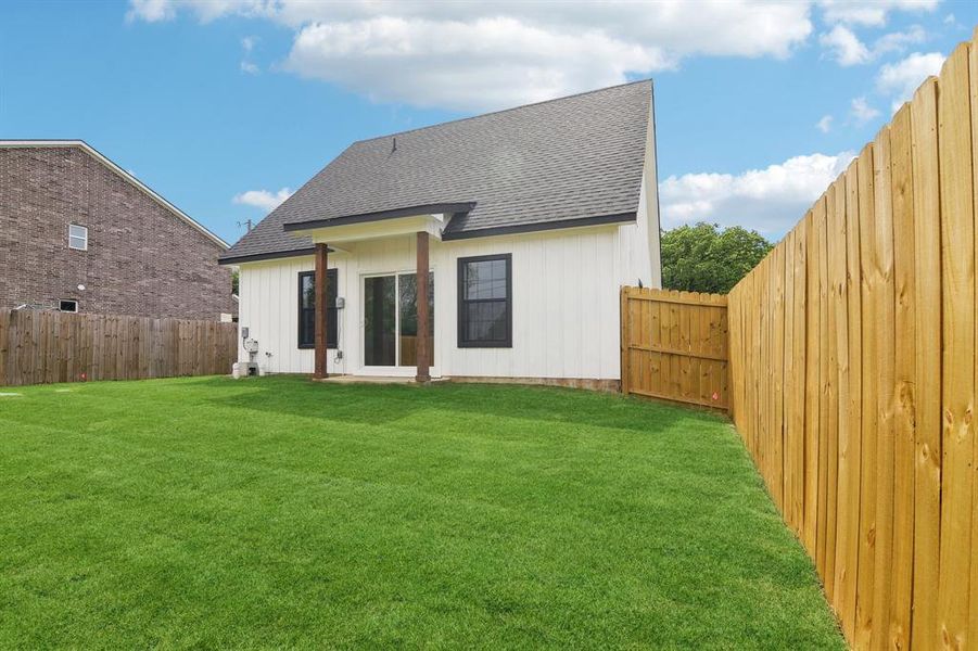 Back yard view with wood privacy fence