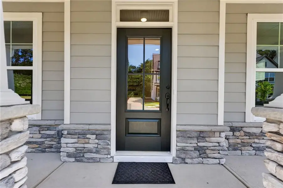 Exterior details and patio area of a home in Marble Tree, Ball Ground (Image 27).