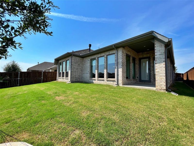 Rear view of house with brick siding and a patio Rear view of house with brick siding and a patio