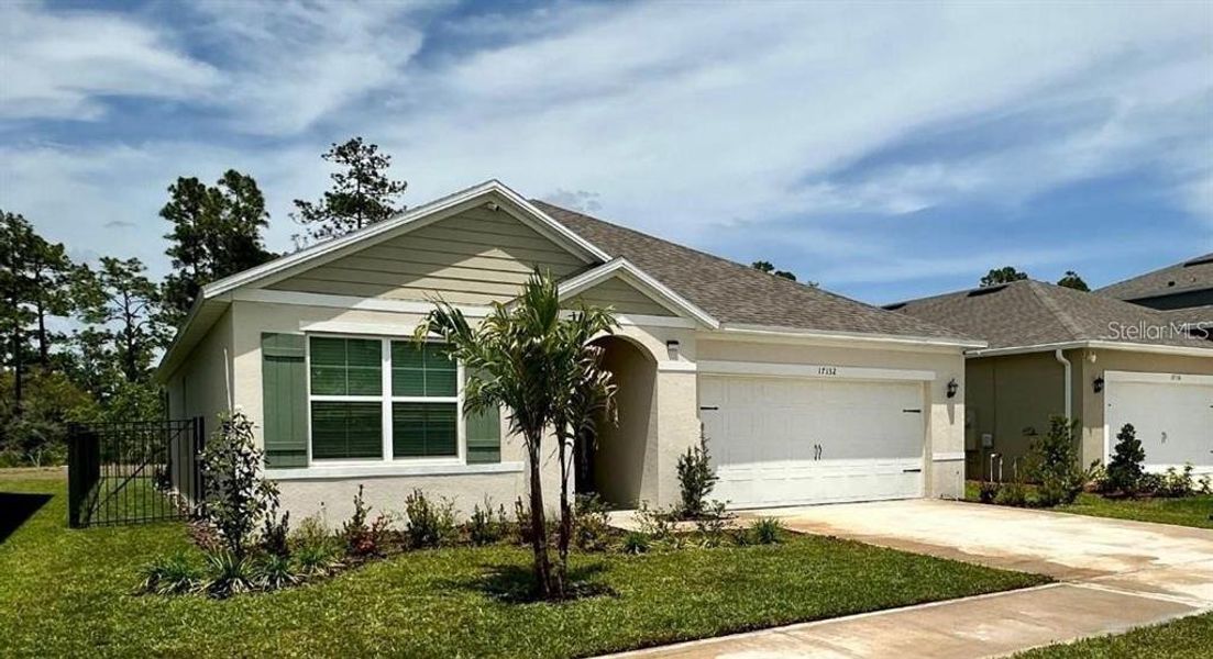 Front exterior of a new home in Edgemont at Serenoa, Clermont, FL, highlighting curb appeal (Image 2). Front exterior of a new home in Edgemont at Serenoa, Clermont, FL, highlighting curb appeal (Image 2).