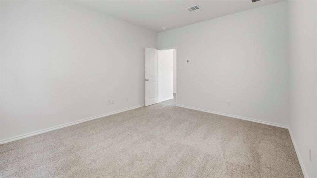 Carpeted spare room with baseboards Carpeted spare room with baseboards
