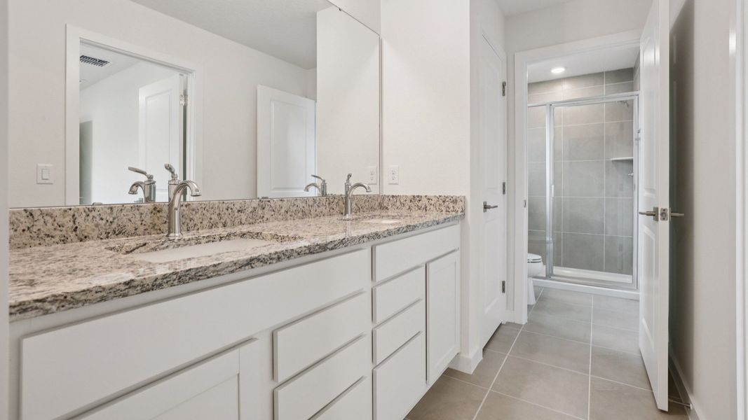 Dual Sinks in the primary bath of the Coronado - End at Cyrene at Harmony located in St Cloud FL by DRB Homes