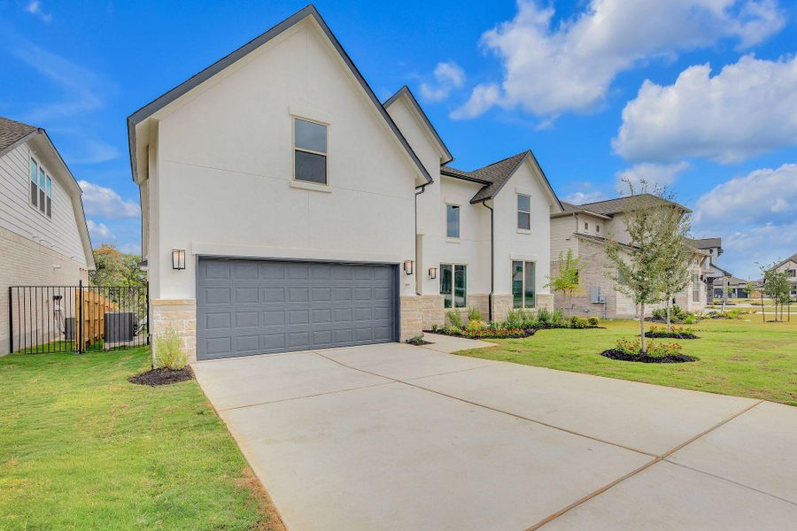 Front exterior of a new home in Santa Rita Ranch, Liberty Hill, TX, highlighting curb appeal (Image 28). Front exterior of a new home in Santa Rita Ranch, Liberty Hill, TX, highlighting curb appeal (Image 28).