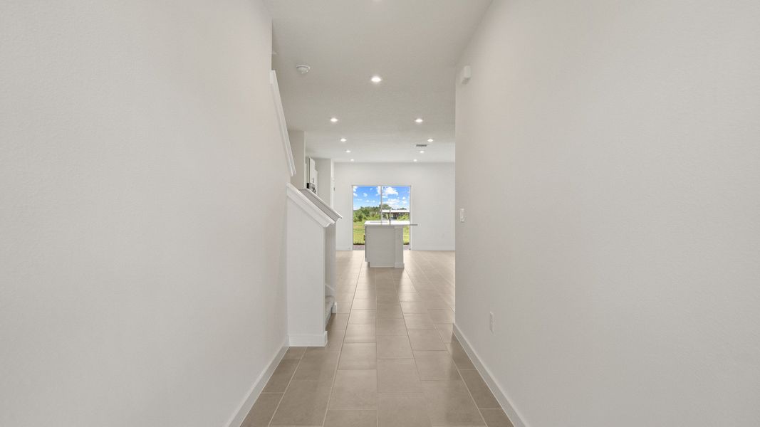 Welcoming entryway in the Ponte Vedra home with sleek flooring, recessed lighting, and a clean and modern look.