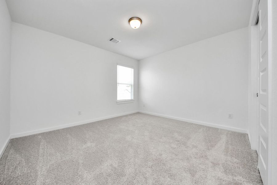 Generously sized secondary bedrooms featuring spacious closets, soft and inviting carpeting underfoot, large windows allowing plenty of natural light, and the added touch of privacy blinds for your personal retreat. Sample photo of completed home with similar floor plan. Actual colors and selections may vary. Generously sized secondary bedrooms featuring spacious closets, soft and inviting carpeting underfoot, large windows allowing plenty of natural light, and the added touch of privacy blinds for your personal retreat. Sample photo of completed home with similar floor plan. Actual colors and selections may vary.