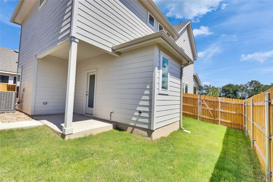 Rear view of property with a patio and a fenced backyard