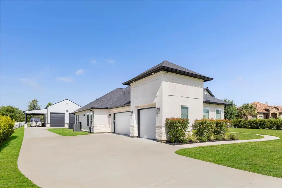 This showcases the 3-car garage, 2-bay air-conditioned & heated shop with a covered carport for RV parking. This showcases the 3-car garage, 2-bay air-conditioned & heated shop with a covered carport for RV parking.