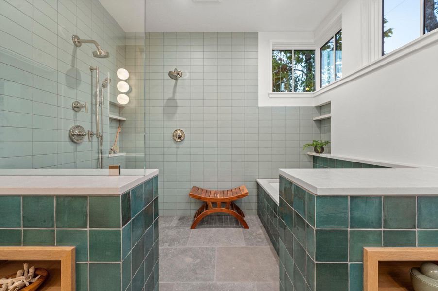 Primary bathroom with stunning tile walls, a walk in shower, and a soaking tub Primary bathroom with stunning tile walls, a walk in shower, and a soaking tub