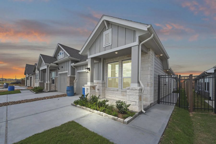 Representative exterior photo of a completed home built from the Carriagehouse by Chesmar Homes in Meridiana Townhomes, Iowa Colony, TX (Image 27).