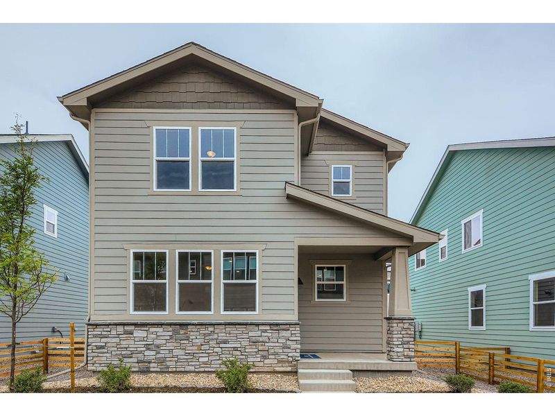 Front exterior of a new home in Waterfield, Fort Collins, CO, highlighting curb appeal (Image 2). Front exterior of a new home in Waterfield, Fort Collins, CO, highlighting curb appeal (Image 2).