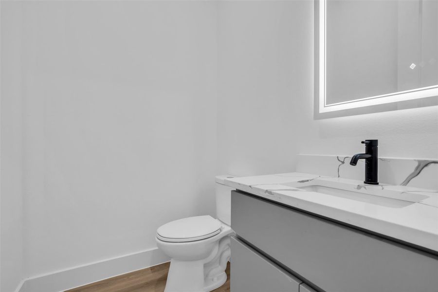 Powder Bath features durable luxury vinyl plank flooring, custom soft close cabinets and quartz vanity tops. Powder Bath features durable luxury vinyl plank flooring, custom soft close cabinets and quartz vanity tops.