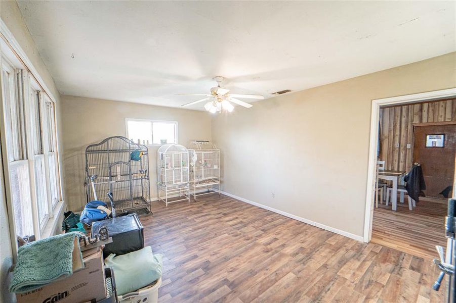 Living room with light wood-style floors and ceiling fan Living room with light wood-style floors and ceiling fan