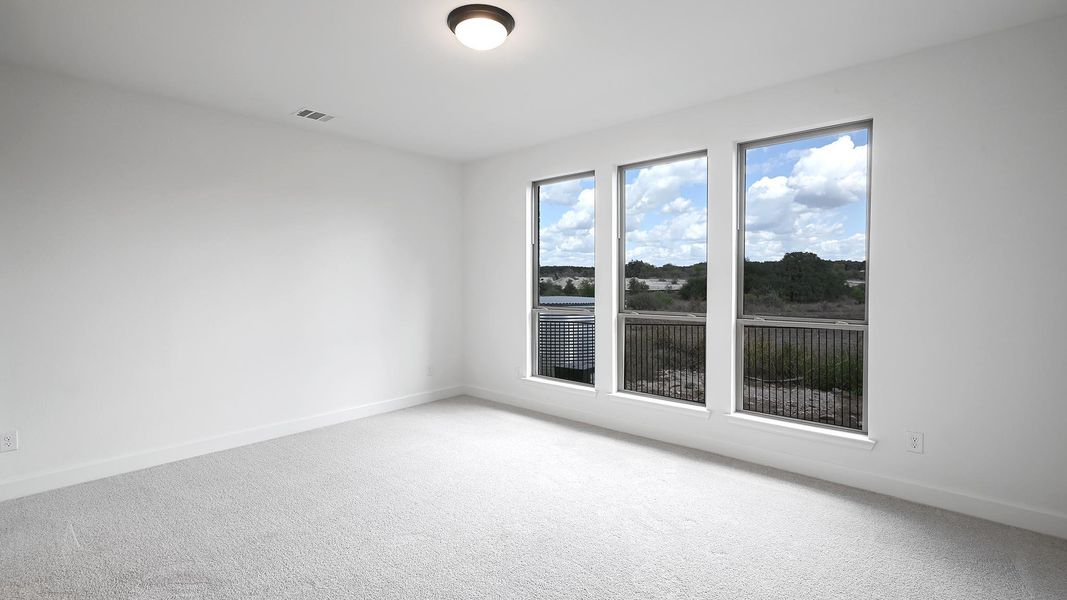 Empty room featuring carpet flooring and baseboards
