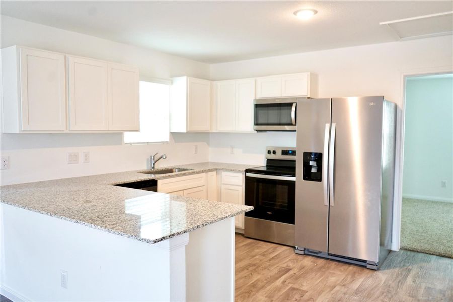 Furnished interior view inside a new home in , Conroe (Image 6).