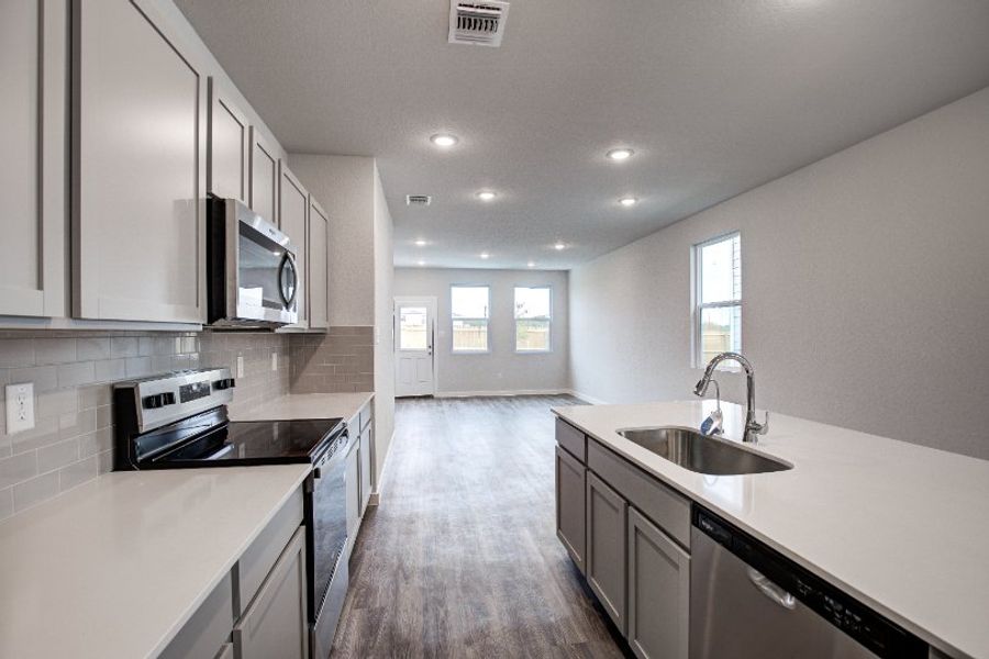 A kitchen with white cabinets.