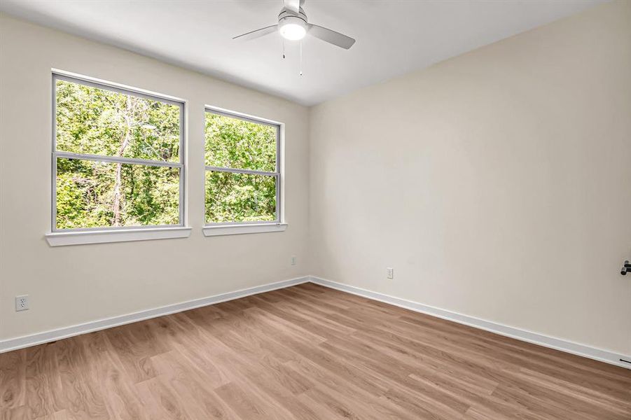 A second guest bedroom on the second floor also overlooks the backyard and is filled with natural light.