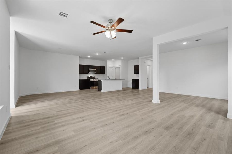 Unfurnished living room with recessed lighting, light wood-style flooring, and a ceiling fan