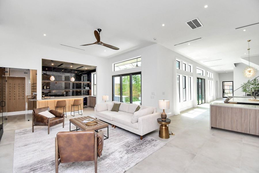 Open living, kitchen, and dining area with sliding doors on both sides for easy access to the side yard/pool area. Open living, kitchen, and dining area with sliding doors on both sides for easy access to the side yard/pool area.