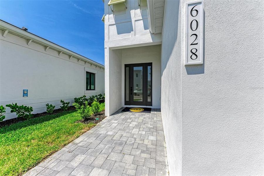 Front exterior of a new home in Aqua Single Family Homes, Bradenton, FL, highlighting curb appeal (Image 2).