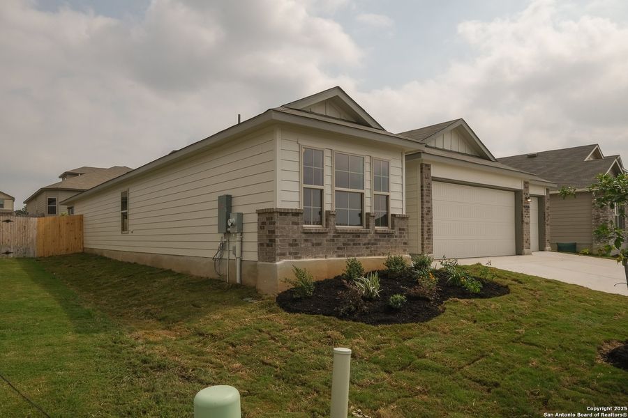 Front exterior of a new home in Greenspoint Heights, Seguin, TX, highlighting curb appeal (Image 21).