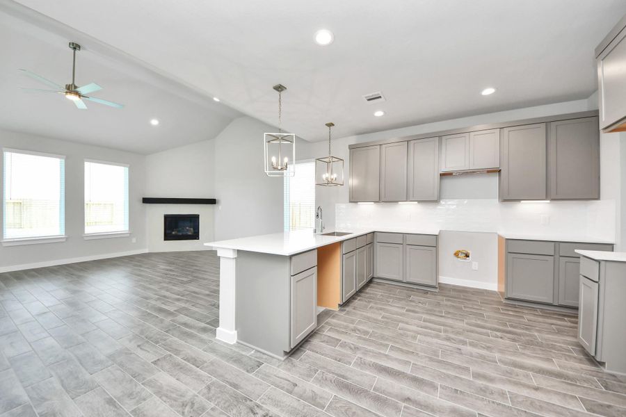 This kitchen is truly a chef's dream! This haven Boasts high ceilings, recessed & pendant lighting, stained wood cabinets, granite countertops, stainless steel appliances, a modern tile backsplash. All of this overlooks your expansive family room, creating a perfect space for culinary delights and family gatherings. Sample photo of completed home with similar floor plan. Actual colors and selections may vary. This kitchen is truly a chef's dream! This haven Boasts high ceilings, recessed & pendant lighting, stained wood cabinets, granite countertops, stainless steel appliances, a modern tile backsplash. All of this overlooks your expansive family room, creating a perfect space for culinary delights and family gatherings. Sample photo of completed home with similar floor plan. Actual colors and selections may vary.