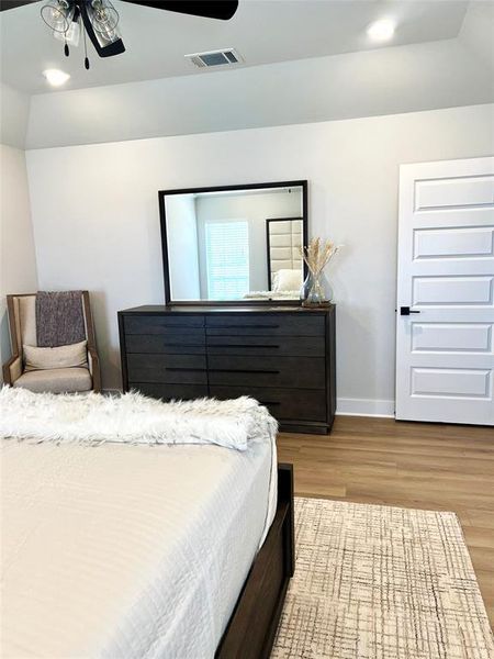 Bedroom with wood finished floors, baseboards, and recessed lighting Bedroom with wood finished floors, baseboards, and recessed lighting