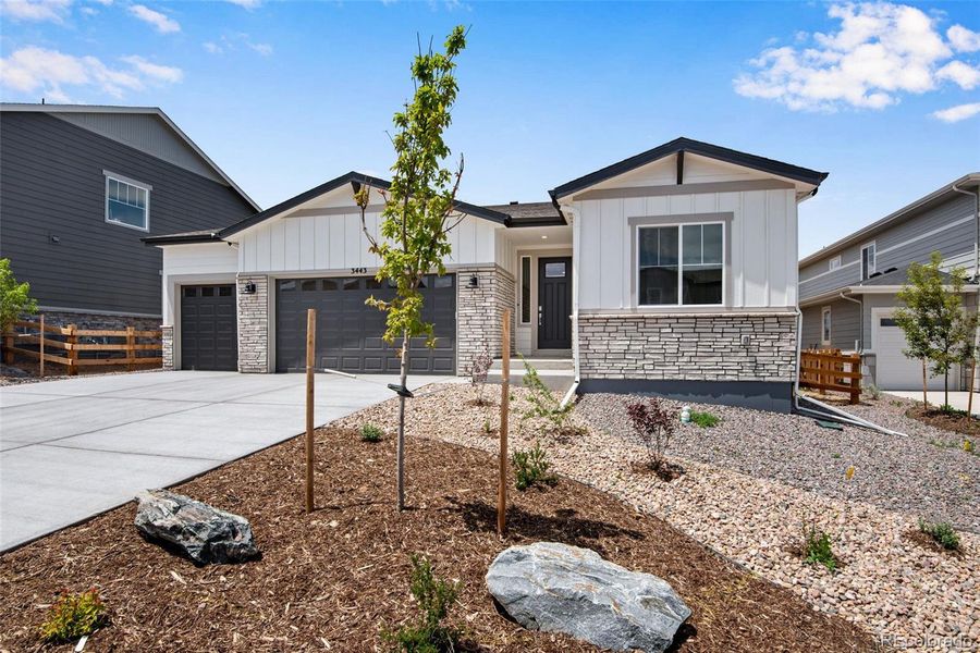 Front exterior of a new home in Ensemble at The Aurora Highlands, Aurora, CO, highlighting curb appeal (Image 1).