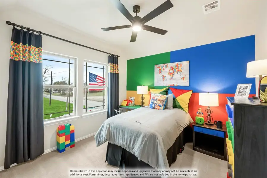 Children's bedroom with colorful Lego-themed decor, bold blue and green accent wall, ceiling fan, and two windows
