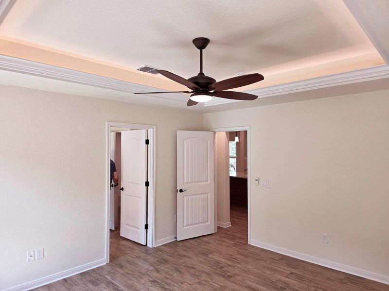 Unfurnished bedroom with wood finished floors and a ceiling fan