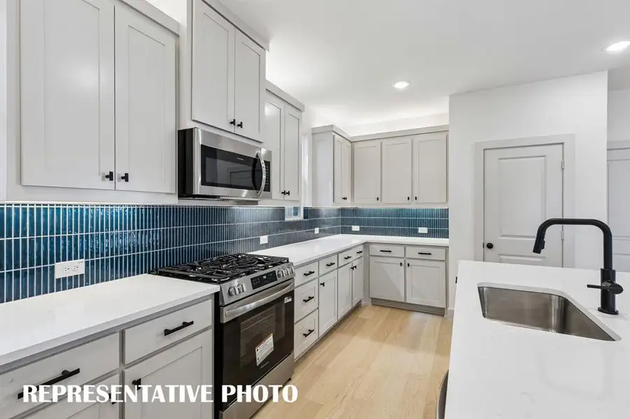 No shortage of storage, prep space or style in this over the top kitchen!  REPRESENTATIVE PHOTO