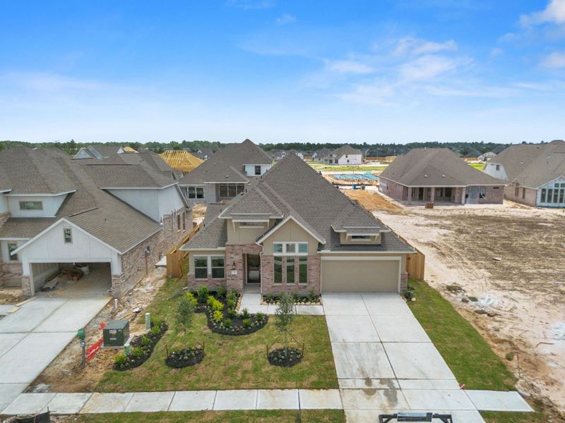Front exterior of a new home in The Meadows at Imperial Oaks 60', Conroe, TX, highlighting curb appeal (Image 1). Front exterior of a new home in The Meadows at Imperial Oaks 60', Conroe, TX, highlighting curb appeal (Image 1).