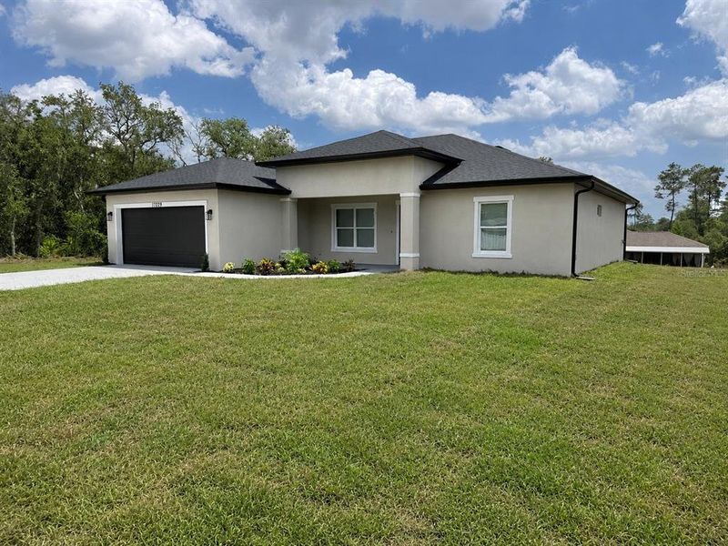 Front exterior of a new home in , Ocala, FL, highlighting curb appeal (Image 22). Front exterior of a new home in , Ocala, FL, highlighting curb appeal (Image 22).