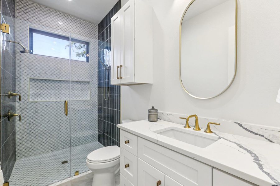 On the first level, a full bathroom serves the guest quarters, ensuring total privacy and convenience for residents or guests occupying the ground floor