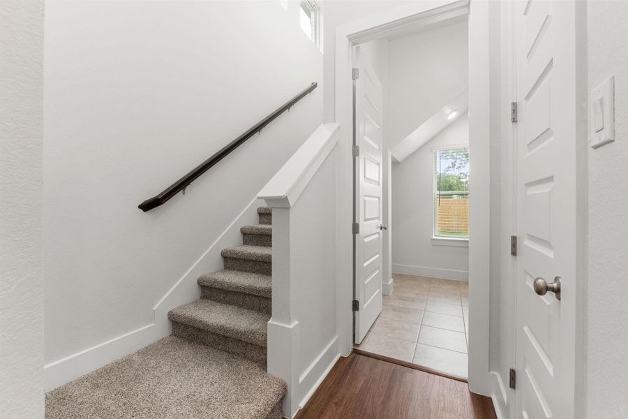 Stairs with wood finished floors, baseboards, and vaulted ceiling Stairs with wood finished floors, baseboards, and vaulted ceiling