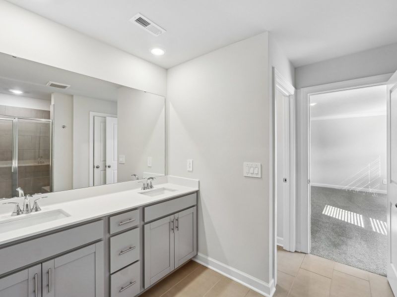 The primary bathroom's dual-sink vanity gives you enough space for all your self-care essentials.