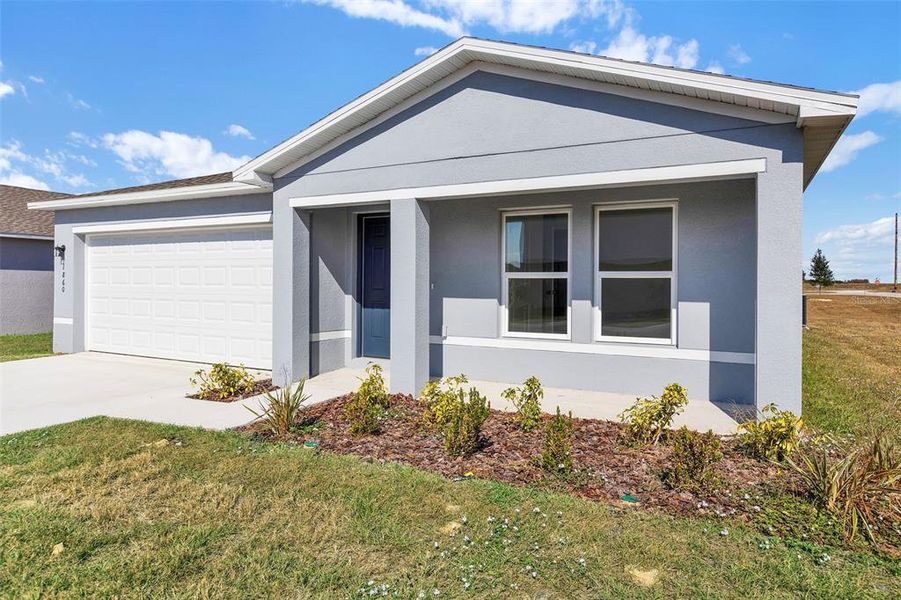 Front exterior of a new home in Stone Ridge, Sebring, FL, highlighting curb appeal (Image 1).