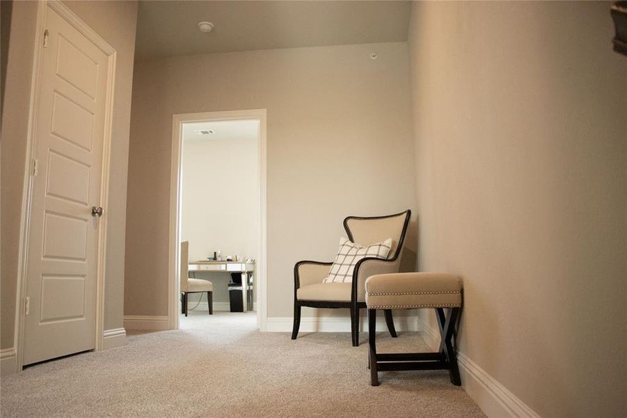 Living area featuring light colored carpet