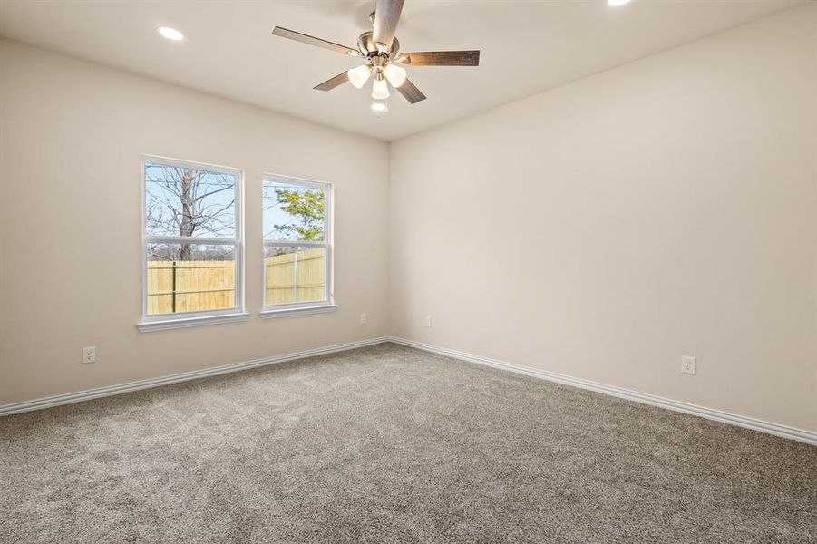 Carpeted spare room with baseboards, a ceiling fan, and recessed lighting