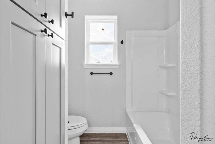 Shower/Tub Combo and a linen closet in bathroom Shower/Tub Combo and a linen closet in bathroom