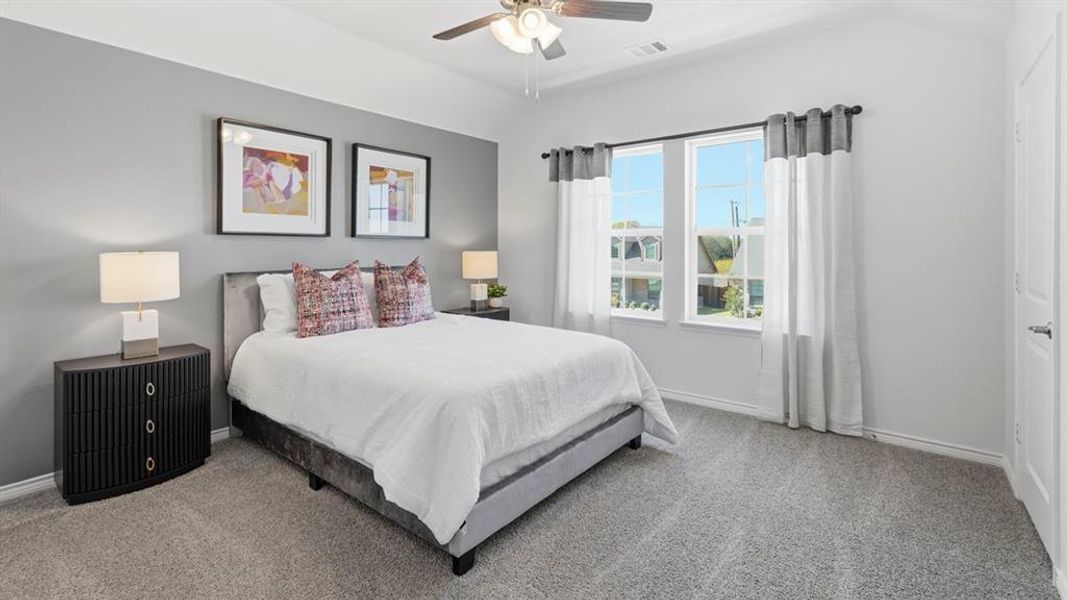 Bedroom featuring carpet, ceiling fan, and vaulted ceiling