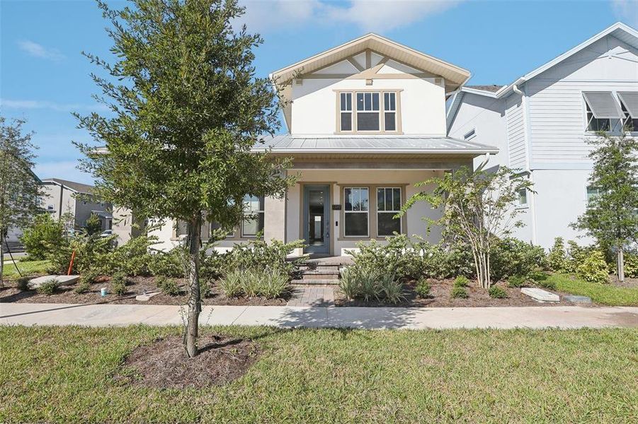 Front exterior of a new home in Laureate Park, Orlando, FL, highlighting curb appeal (Image 26).