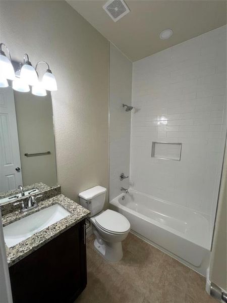 Full bath featuring shower / bathtub combination, vanity, and a textured wall