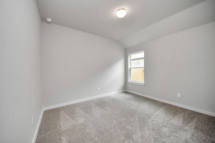 Secondary bedroom features plush carpeting, large windows that let in plenty of natural light, bright paint, and spacious closets. Sample photo of completed home with similar floor plan. Actual colors and selections may vary. Secondary bedroom features plush carpeting, large windows that let in plenty of natural light, bright paint, and spacious closets. Sample photo of completed home with similar floor plan. Actual colors and selections may vary.