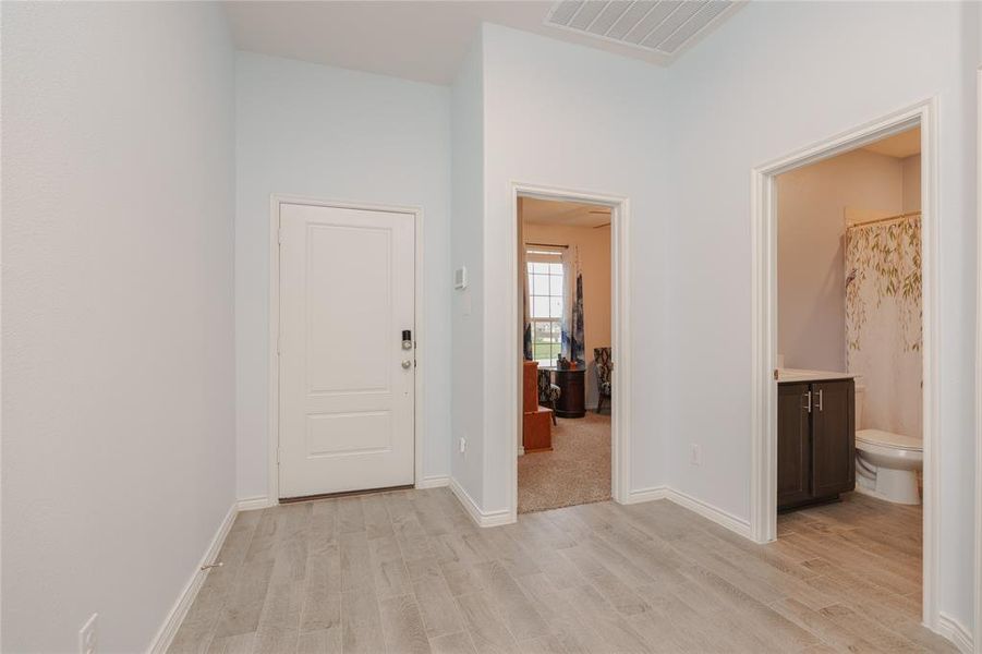 Hallway with light hardwood / wood-style flooring