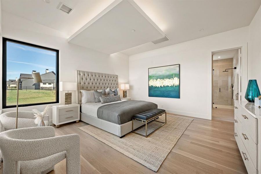 Elegant primary suite with vaulted ceiling and natural light. Elegant primary suite with vaulted ceiling and natural light.