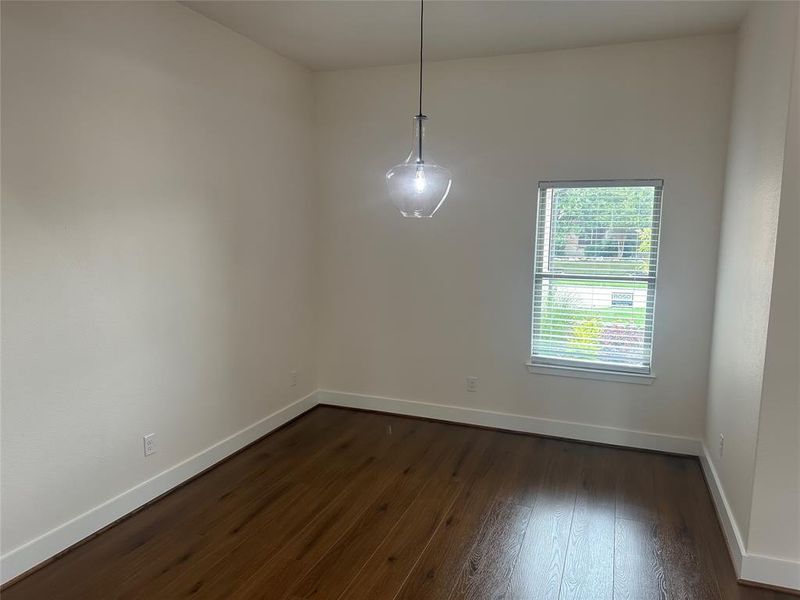 Empty room featuring dark wood-type flooring