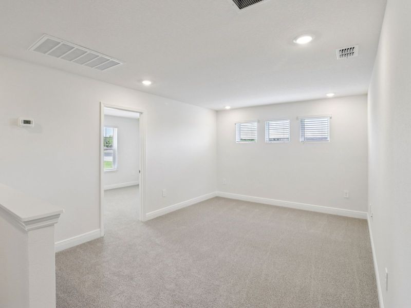 Spacious, unfurnished interior of a new home in The Reserve at Hammock Oaks - Signature Series, Lady Lake (Image 12).