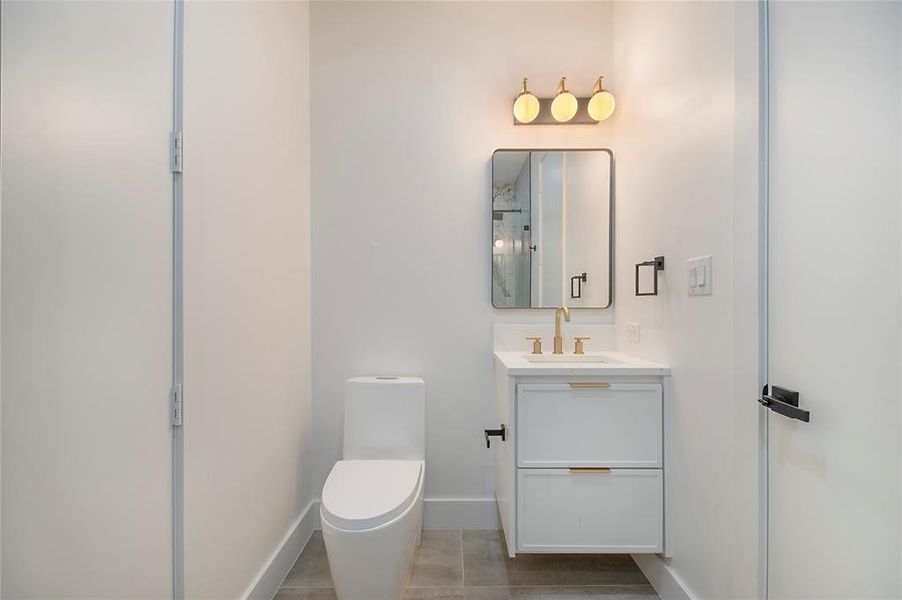 Bathroom featuring vanity, a shower stall, and light tile patterned flooring Bathroom featuring vanity, a shower stall, and light tile patterned flooring
