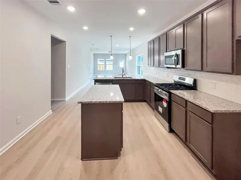The Cardinal II- Spacious Kitchen with Ample Cabinet and Countertop Space. Home under construction, photo used for illustrative purposes only, colors and options will vary The Cardinal II- Spacious Kitchen with Ample Cabinet and Countertop Space. Home under construction, photo used for illustrative purposes only, colors and options will vary